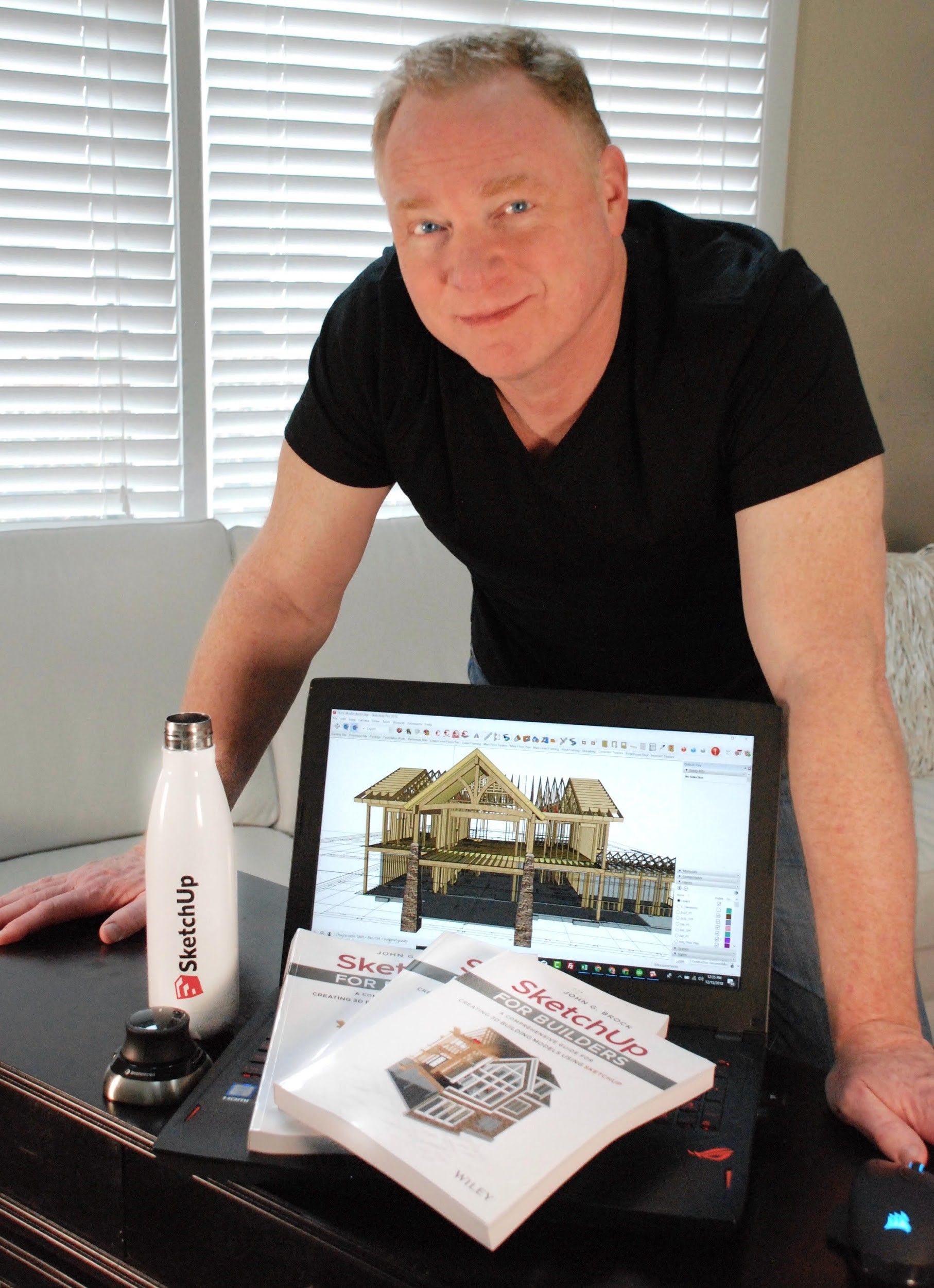 John showing off his book, “SketchUp for Builders”