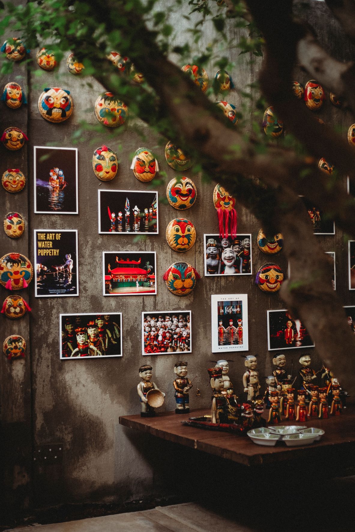 Tuong (Traditional Opera) masks and pictures hang on the restaurant wall.
