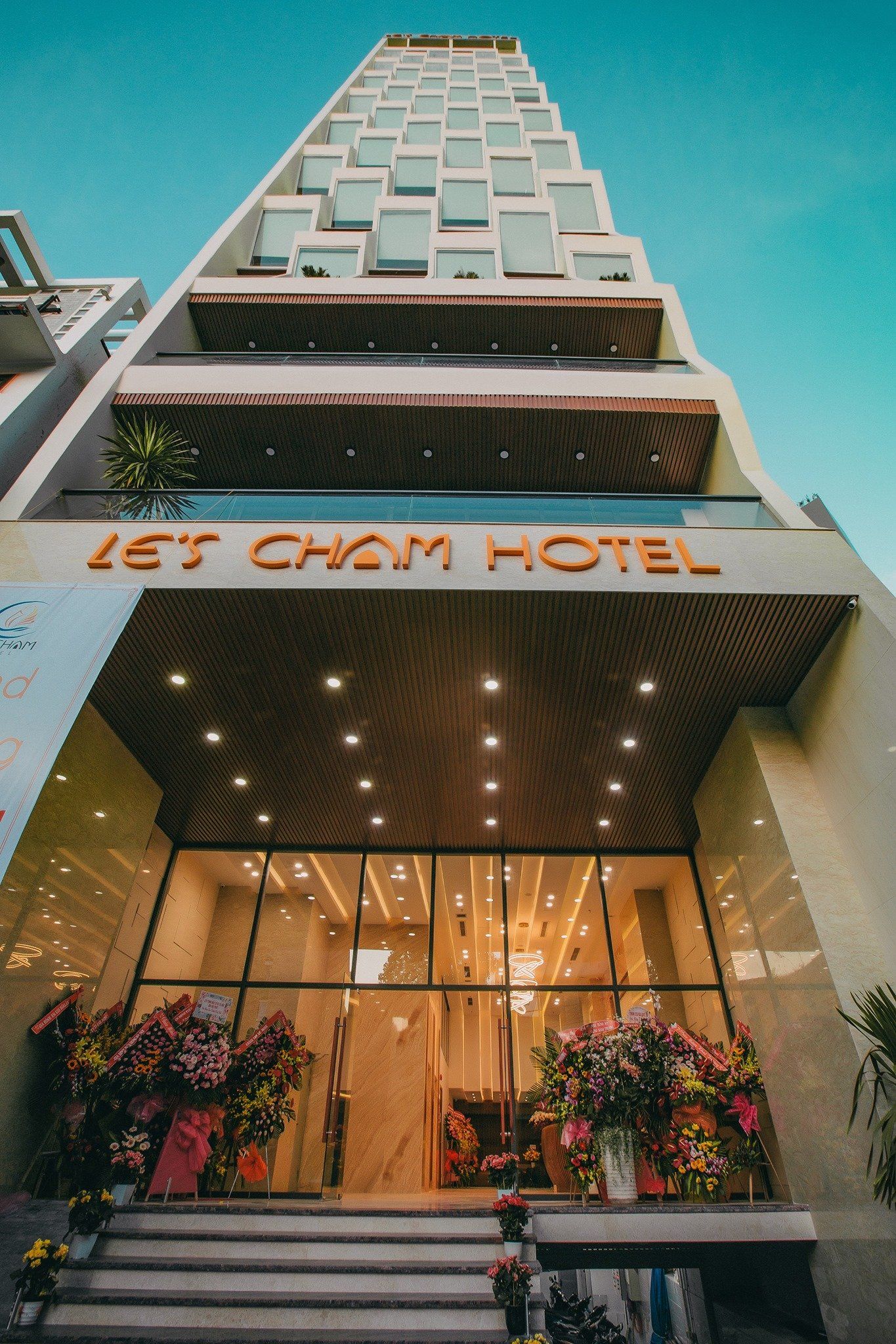 The completed Le’s Cham Hotel during its grand opening in 2019, with its glamorous facade and inviting interior.