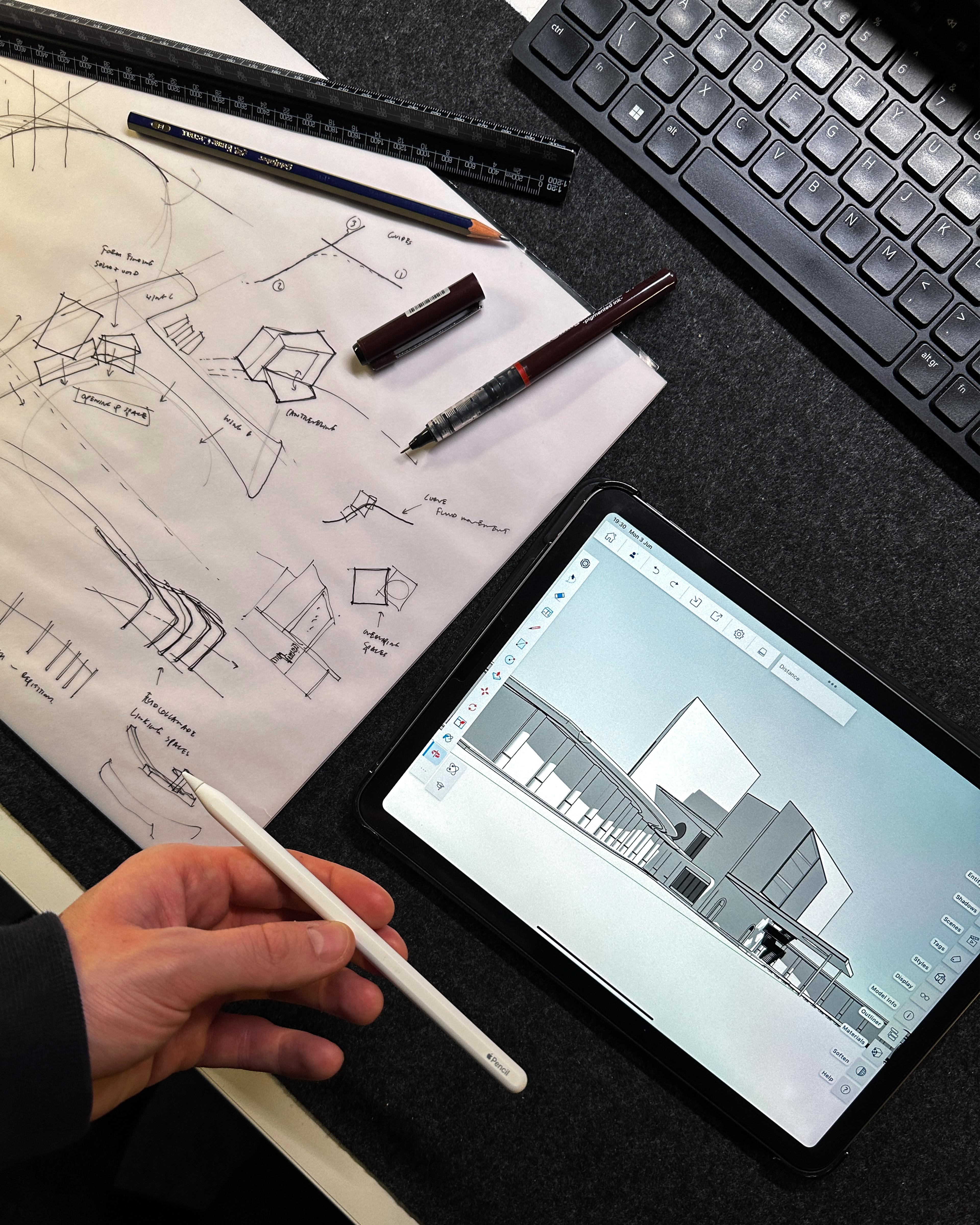 SketchUp model of a deconstructivist building on an iPad and sketches on paper.